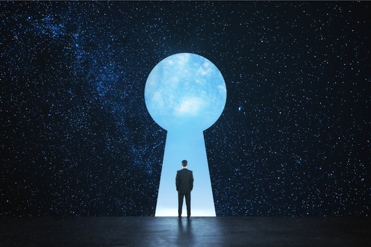 Man walking through lock-shaped door against starry background.
