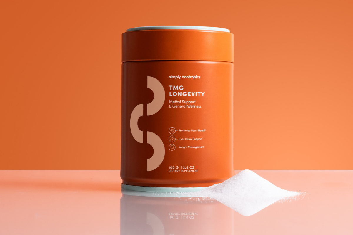 Orange container of Simply Nootropics TMG Longevity powder with a small pile of white supplement powder.