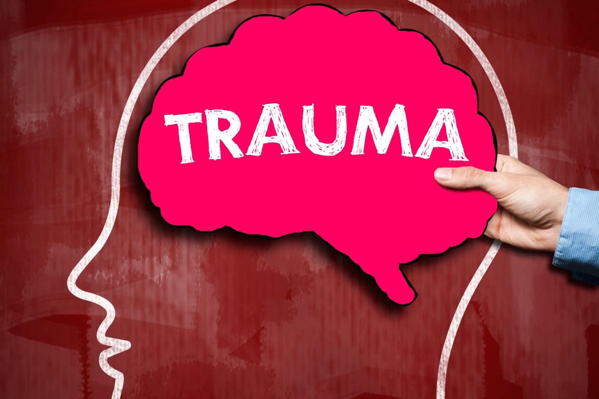 Illustration of a brain shape with the word trauma inside.