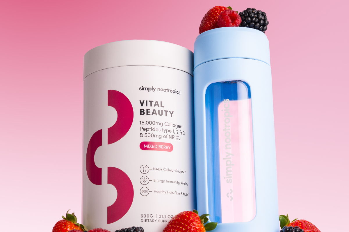 Simply Nootropics Vital Beauty collagen tub with blue shaker bottle and berries on pink background.